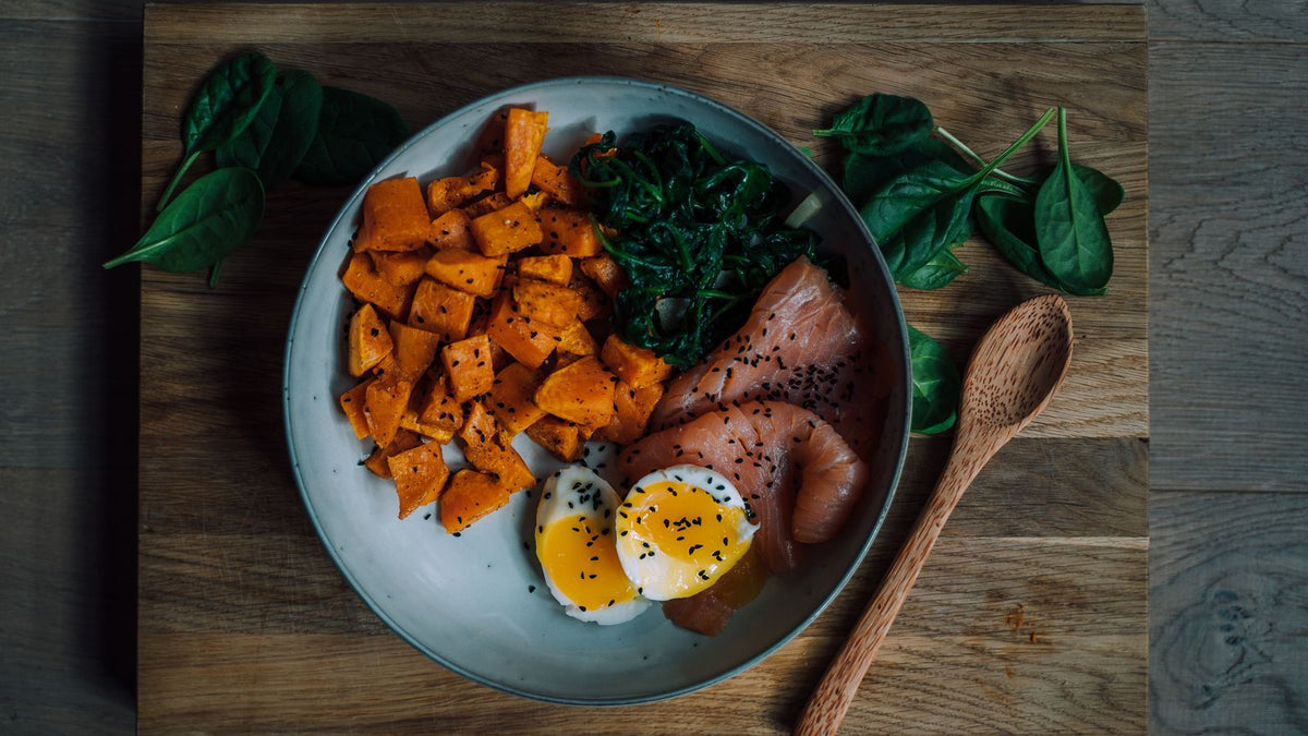 Plate of salmon, sweet potato and eggs, three of the best foods for hair growth