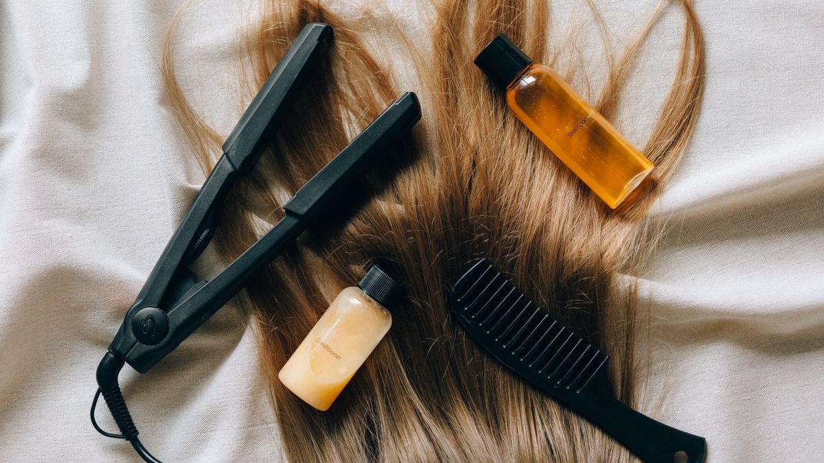 Flat lay of shampoo, brushes and bottles while comparing the best hair growth products