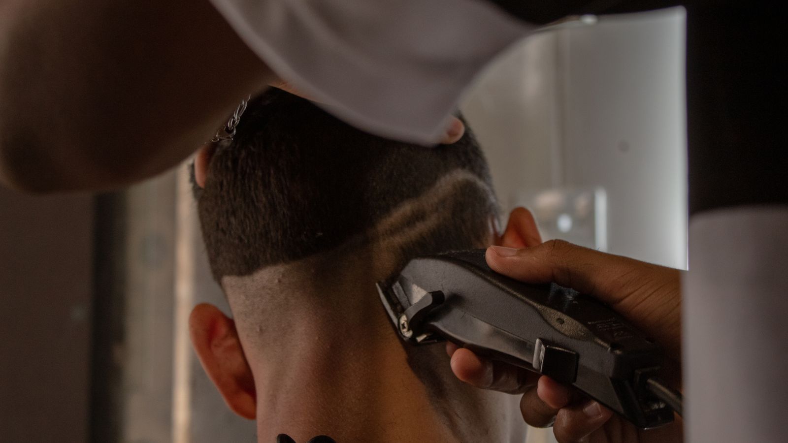 Barber cutting a textured crop, one of the best haircuts for men's thin hair