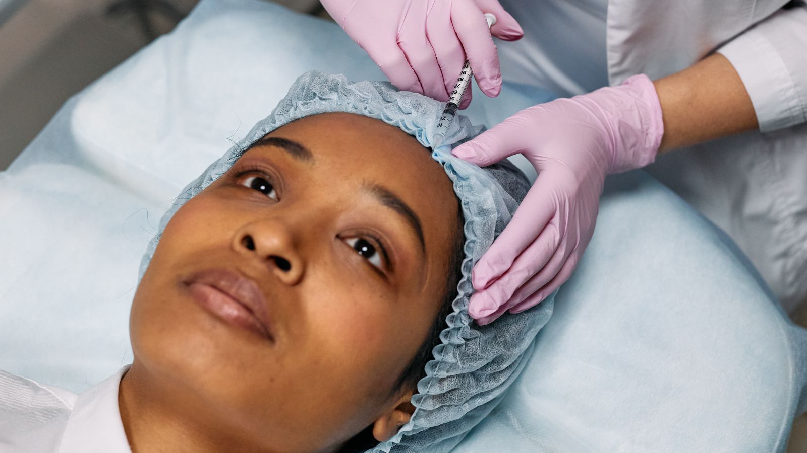 Close-up of a botox and fillers treatment being administered to the forehead in a clinic setting