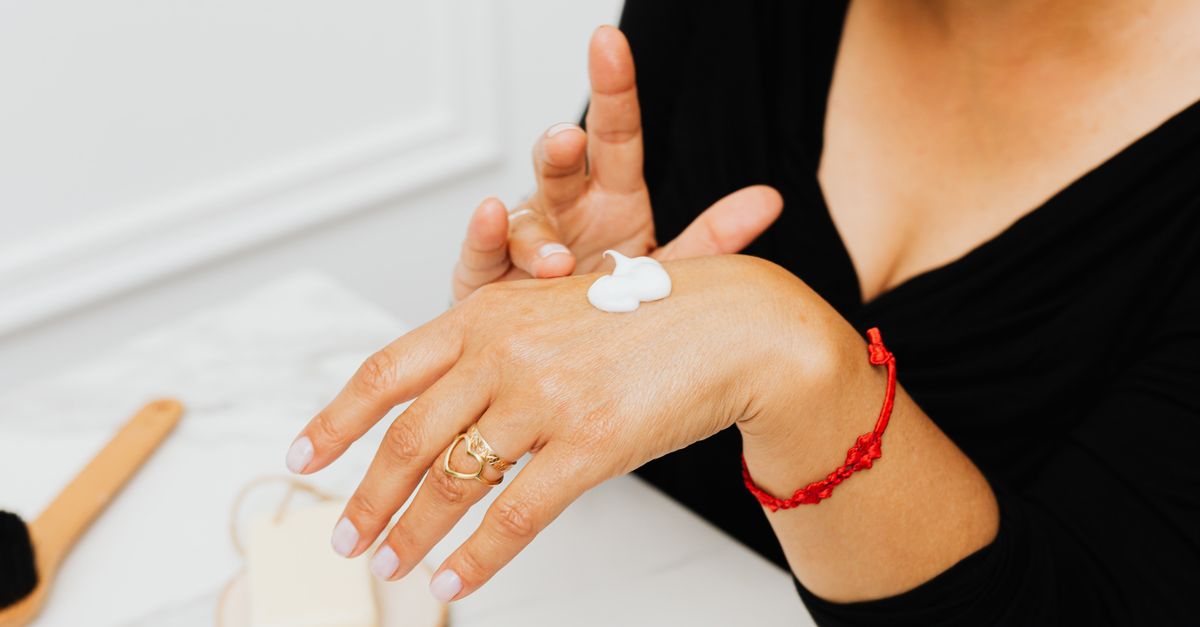 Woman applying cream to her hands, the simplest fix for dry hands