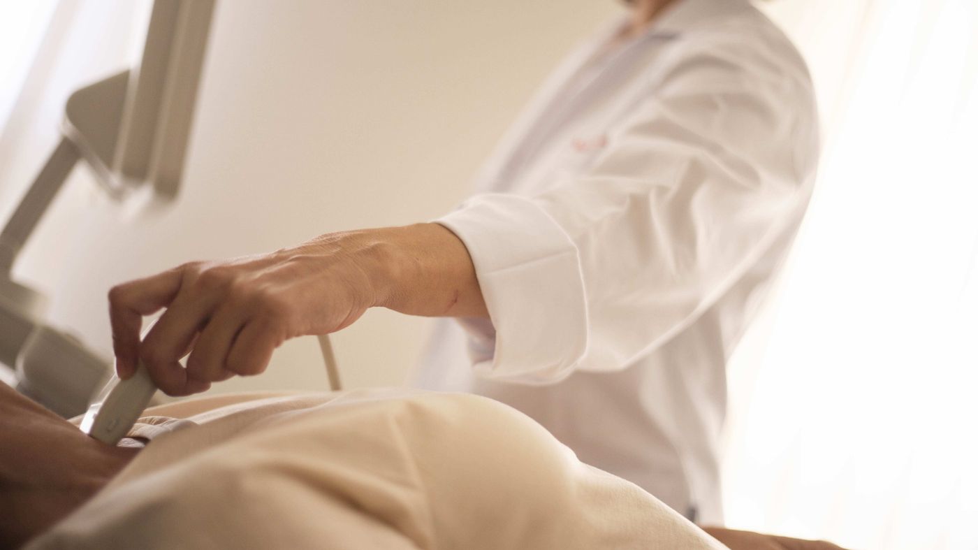 Medical professional performing an abdominal ultrasound, the scan that usually finds fatty liver symptoms