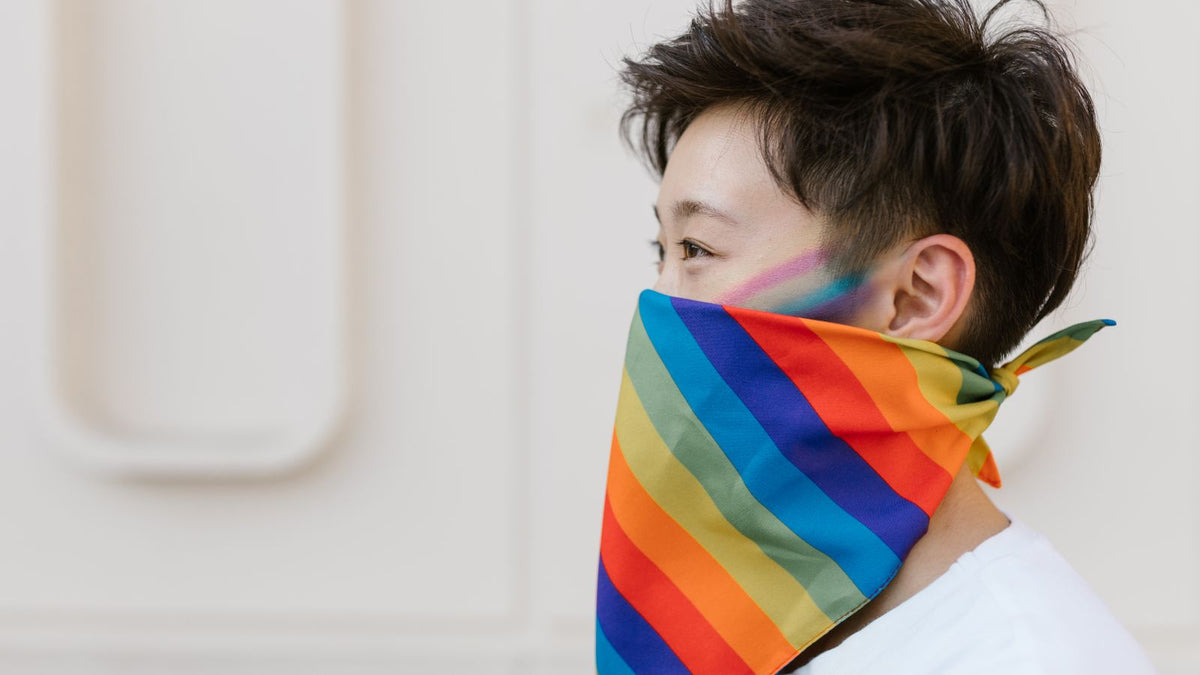 Person with short hair and a rainbow bandana, a gender-affirming hair look