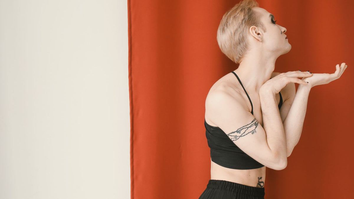 Person posing confidently, representing gender-affirming hormone therapy hair changes