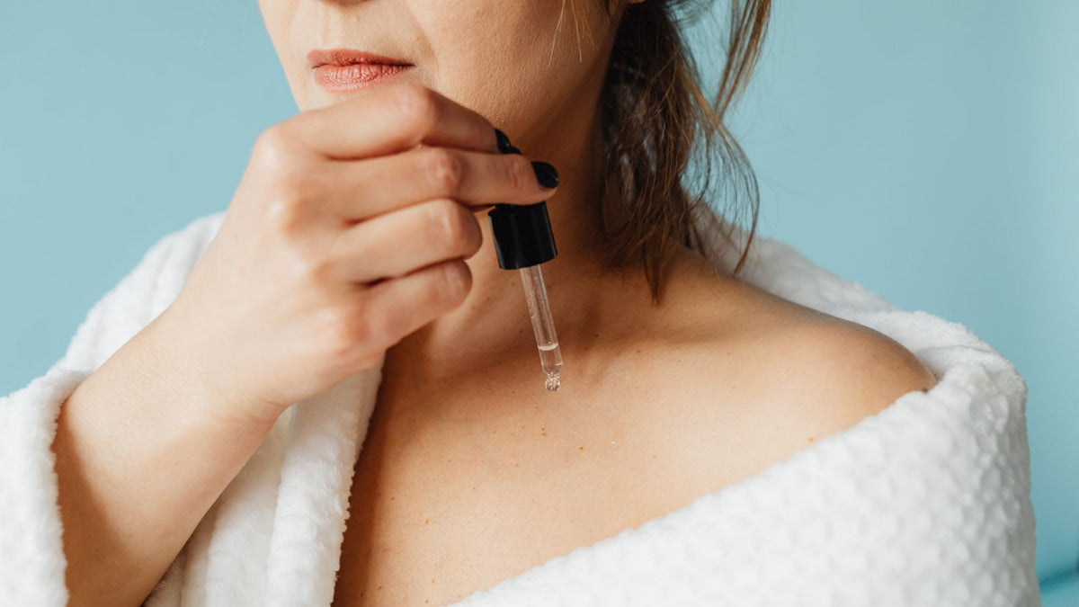 Applying a scalp serum with a dropper along the parting, ghk-cu hair growth routine