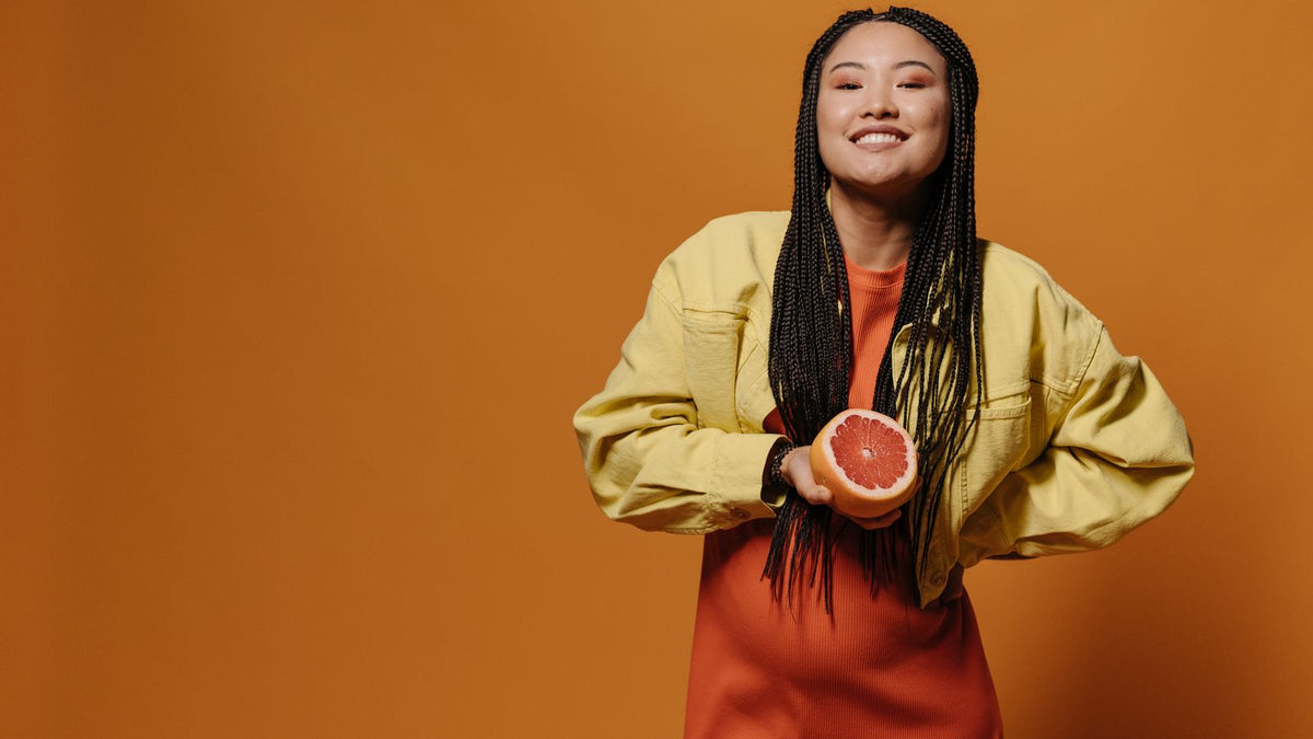 Woman smiling with healthy looking braided hair after losing weight, the turning point of hair recovery after weight loss
