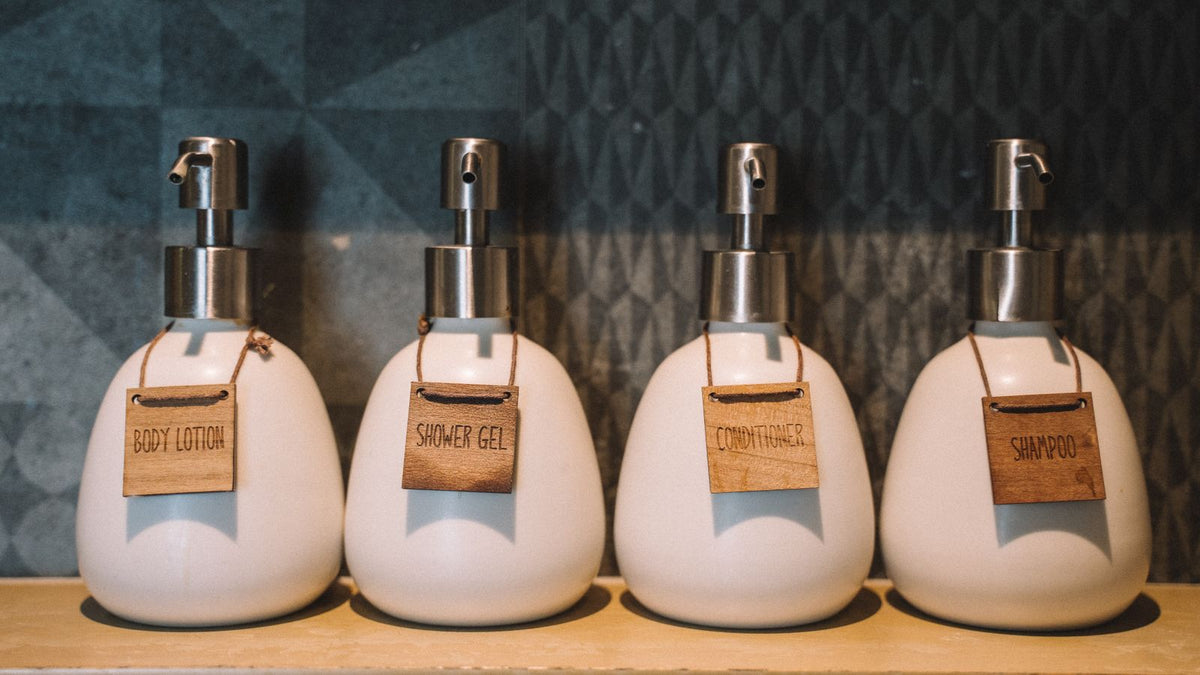 Shelf of hair strengthening products uk bathrooms typically hold, lined up by wash day order