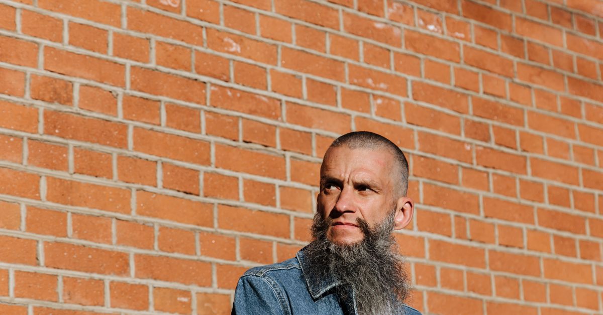 Portrait of a bearded man, reflecting hair thinning on testosterone over time