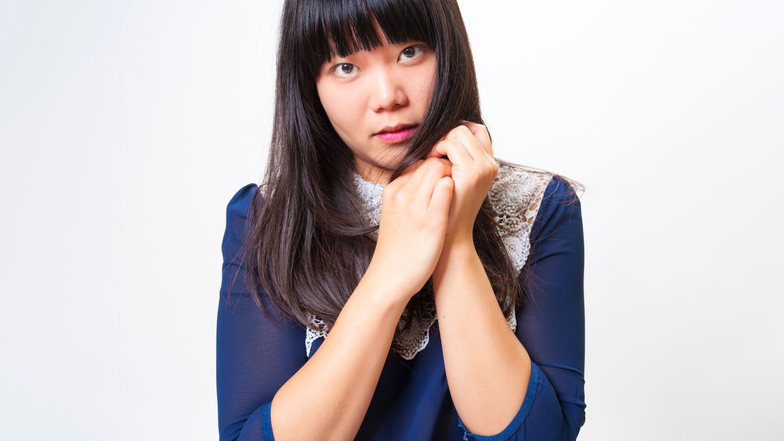 Woman styling the front of her hair to hide thinning