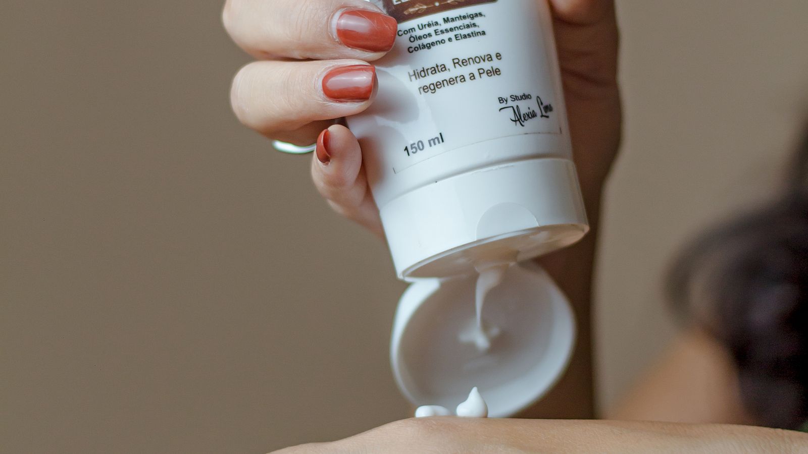 Applying nourishing oil to dry hands in winter