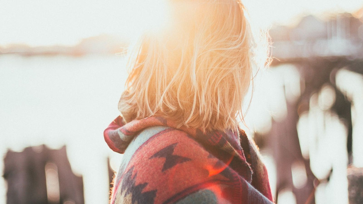 Woman with shiny healthy hair in the sunshine after switching to a gentle shampoo