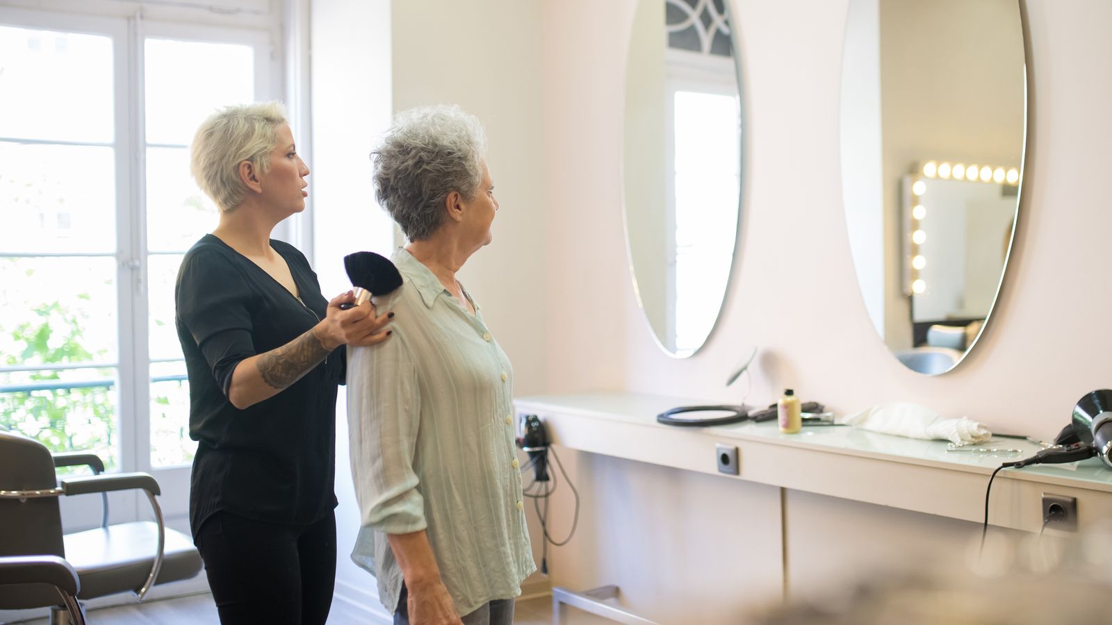 Hair stylist working with a woman in her fifties, HRT and hair density care