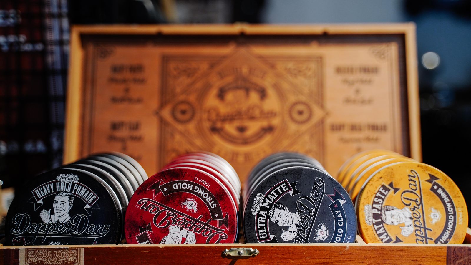 Vintage style hair pomade tins on a shelf, the products behind the question is pomade bad for your hair