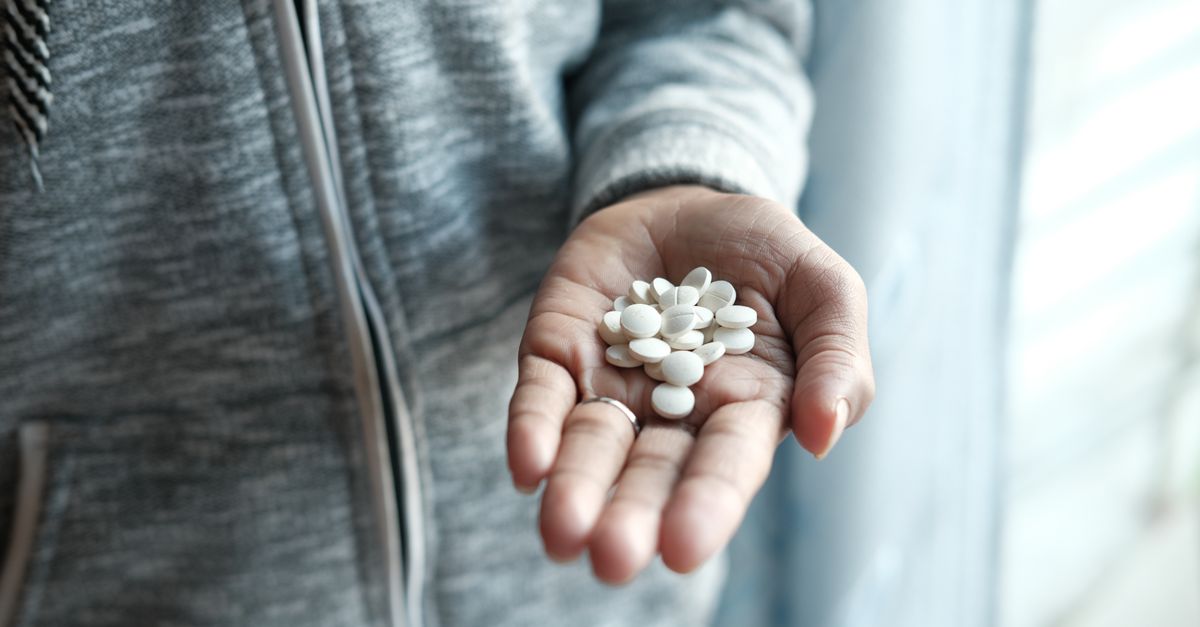 Keratin vitamins for hair, tablets held in an open palm