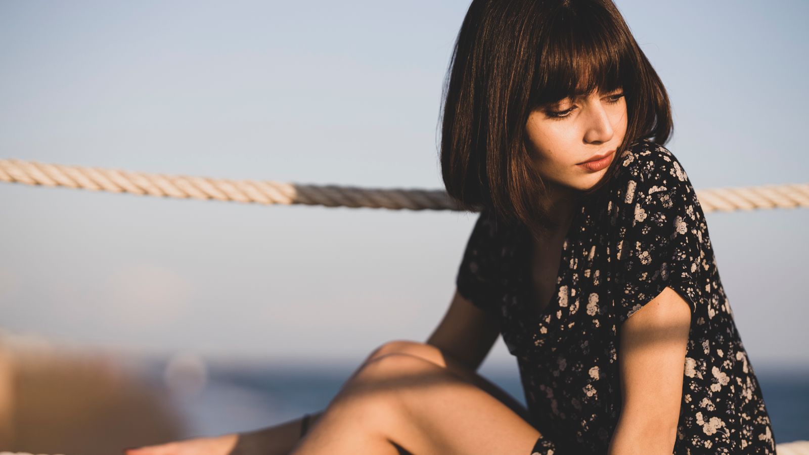 Woman with bangs framing her face, a flattering style for a low hairline