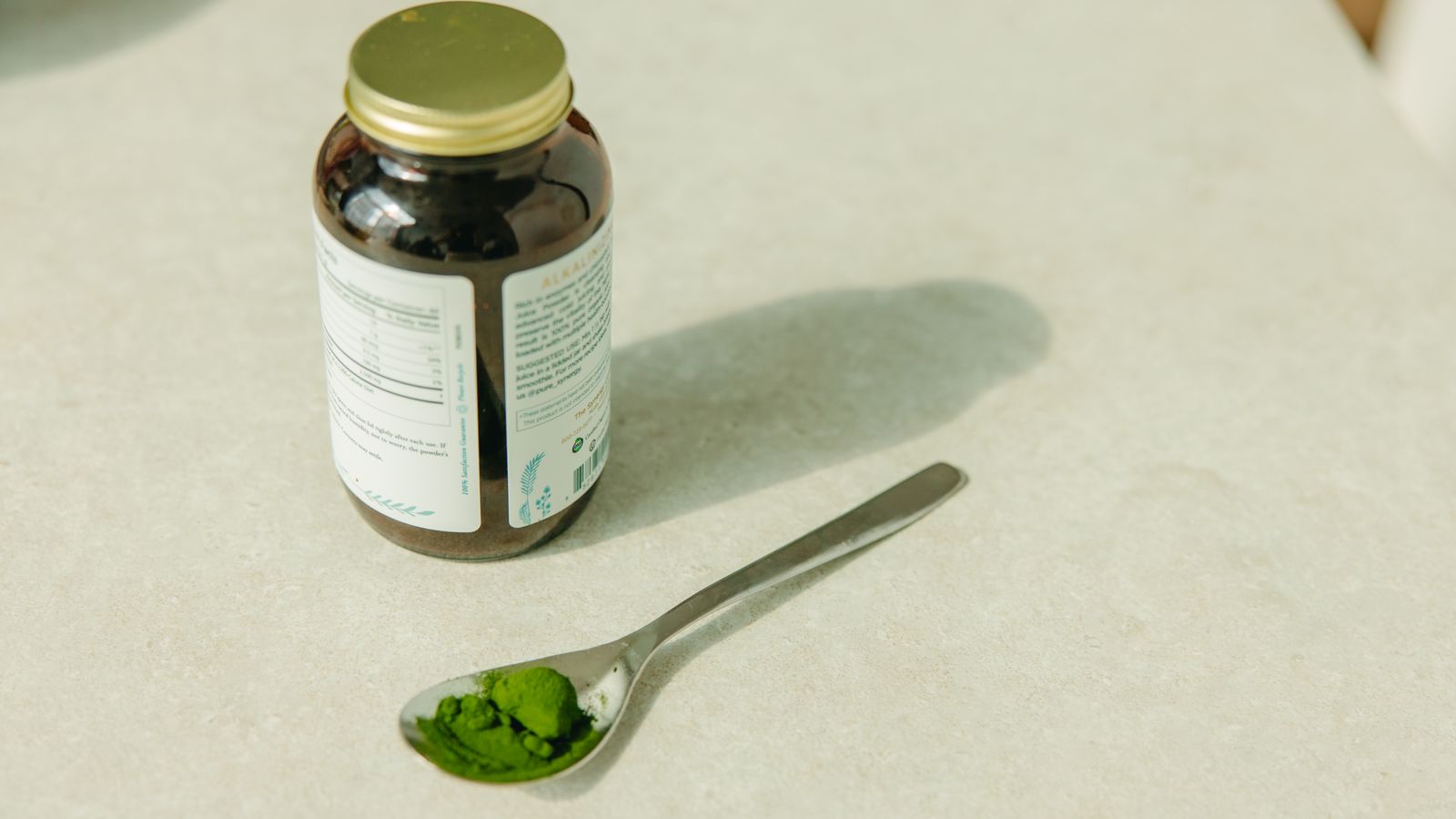 Jar of maca root powder, a superfood used to support hair growth and wellness