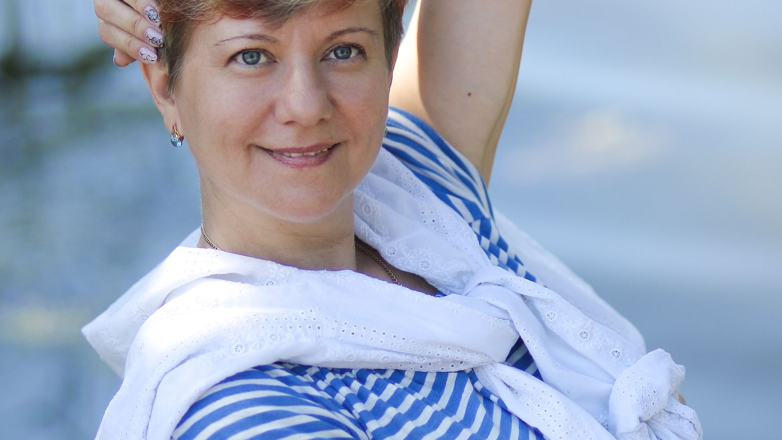 Smiling woman in her 50s with healthy short hair, menopause hair care