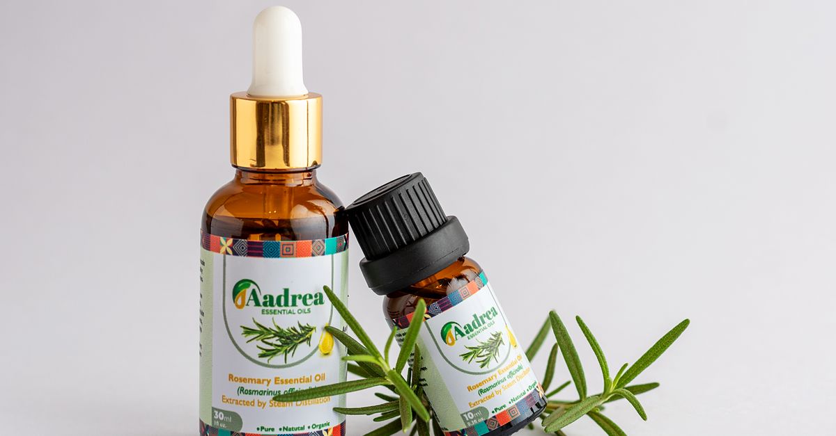 Bottle of rosemary essential oil with fresh sprigs, one of the natural hair loss remedies people try first