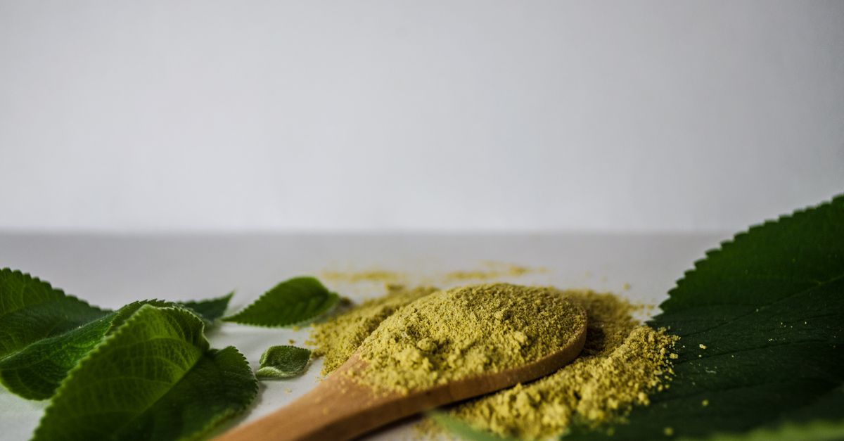 Herbal brahmi powder on a wooden spoon for a hair mask