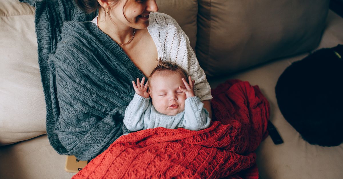 New mother holding her baby during postpartum hair loss