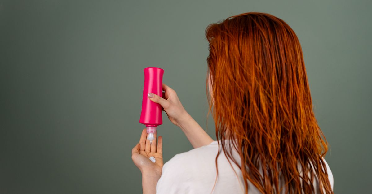 Woman conditioning hair to repair damage and restore shine