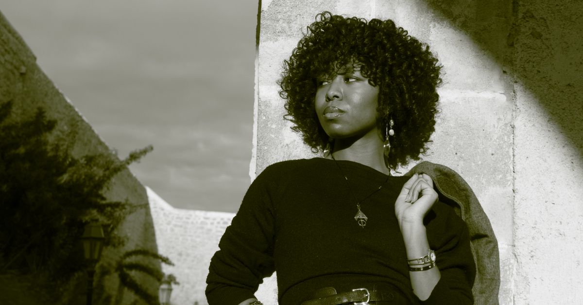 Woman with textured hair caring for relaxed hair