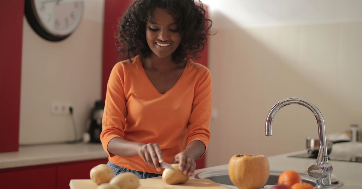 Smiling woman in her kitchen on a healthy weight-loss journey