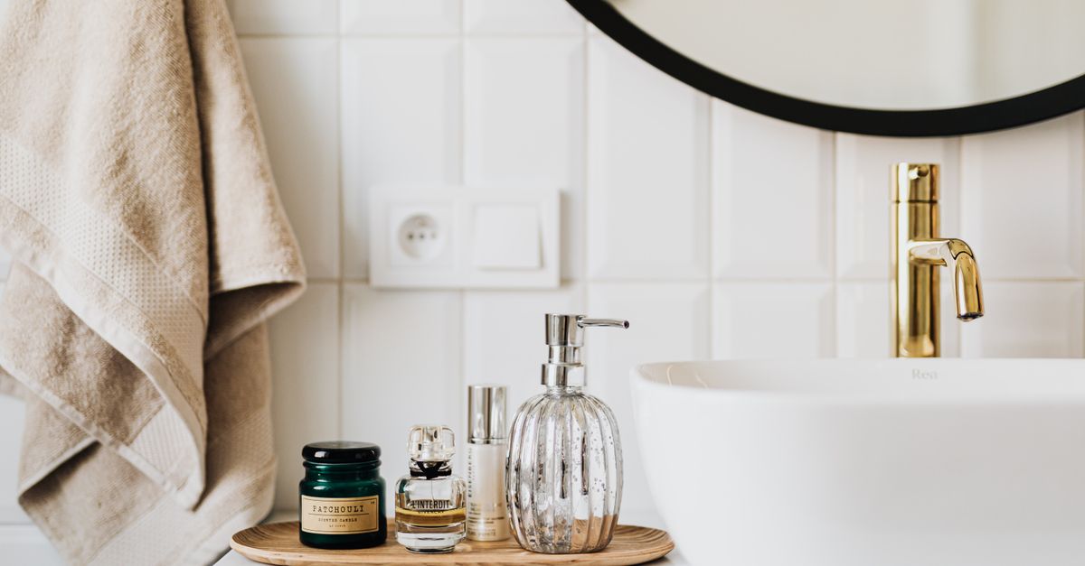 Skincare and treatment bottles on a bathroom shelf