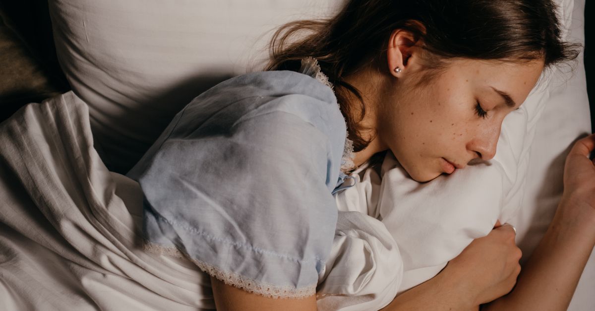 Woman sleeping peacefully, linking sleep and hair health