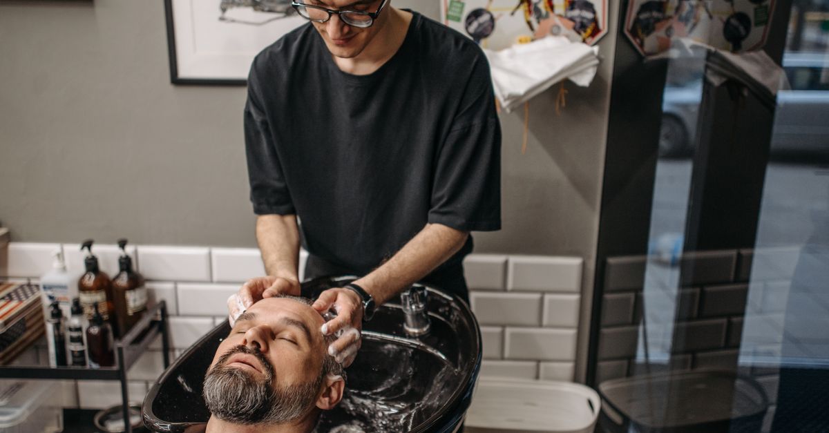 Hair being washed with a gentle cleanser at a salon basin