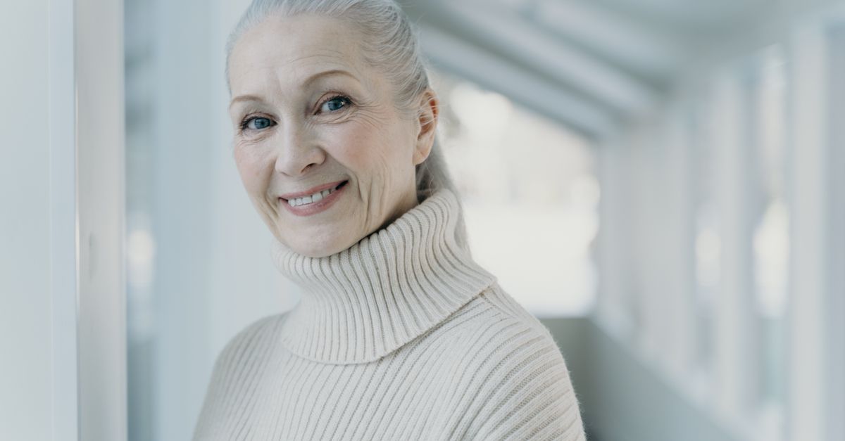 Smiling woman with grey hair, scalp estrogen receptors change through midlife