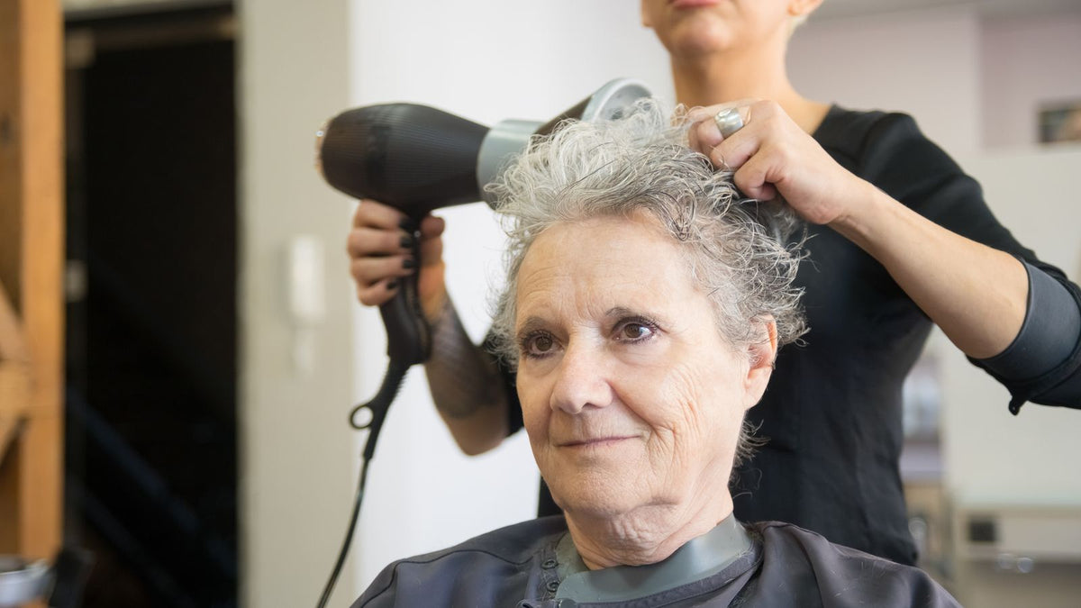 Older woman having a gentle blow dry, the reader looking for a shampoo for older women