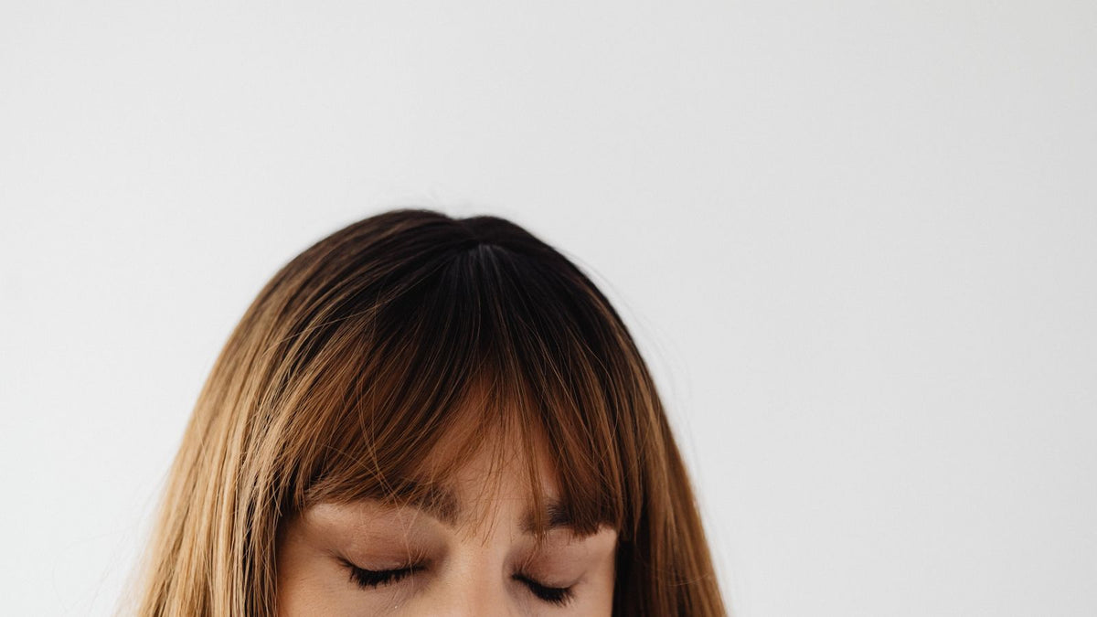 Woman with brunette hair partway through a shedding timeline