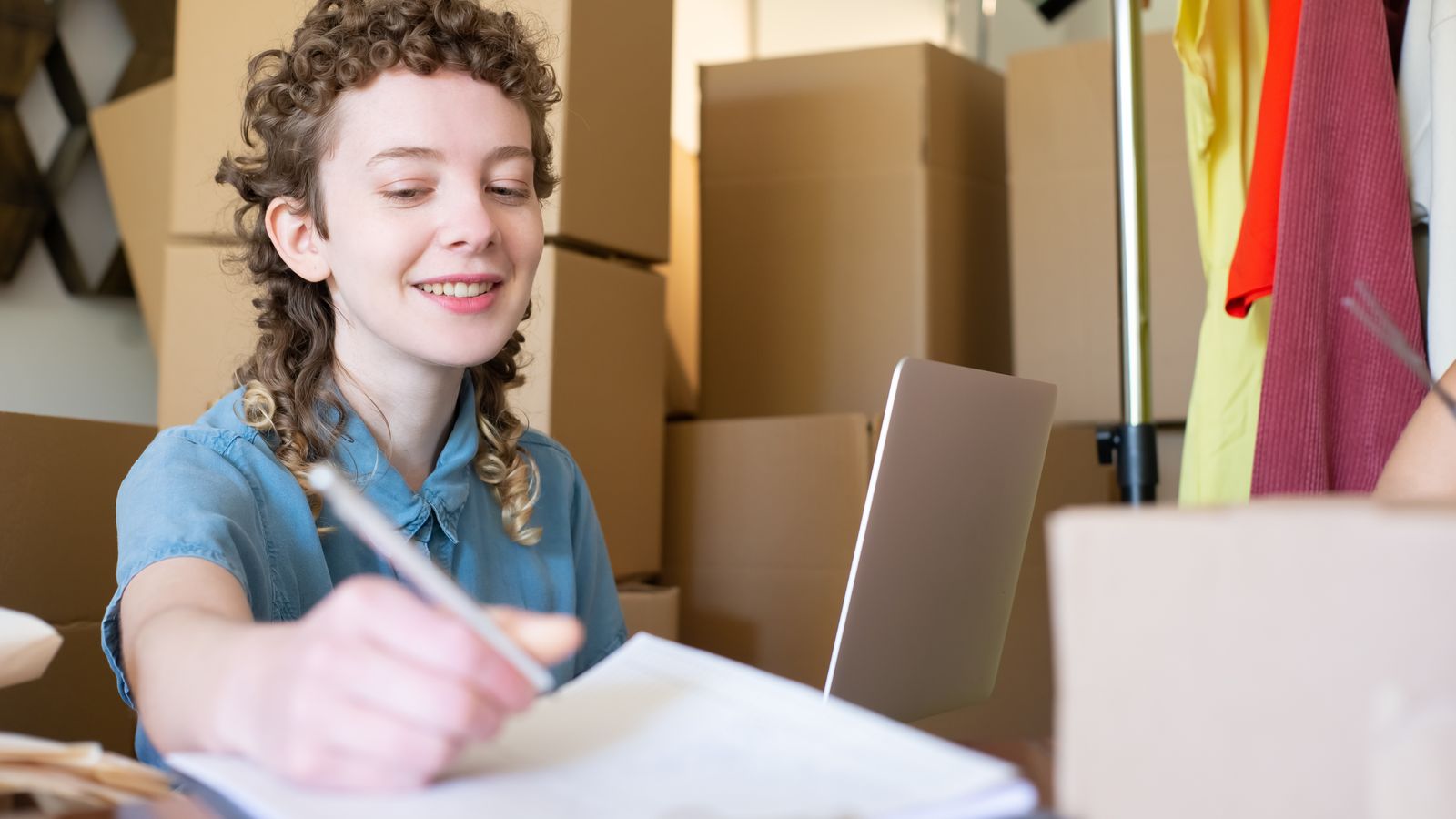 Small business owner packing hair oil orders at home