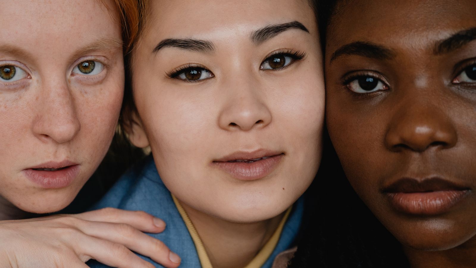 Three people with different natural skin tones, explaining why sunburn vs tan differs between people