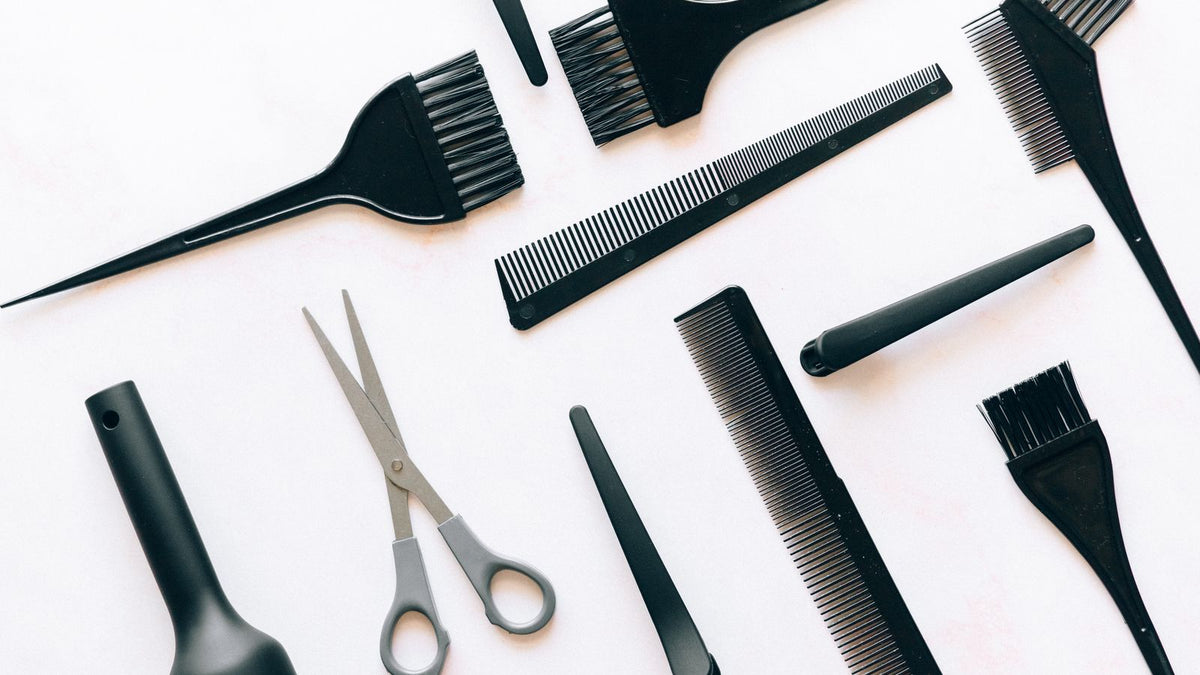 Brushes and combs laid out, the everyday tools that first reveal what causes hair loss