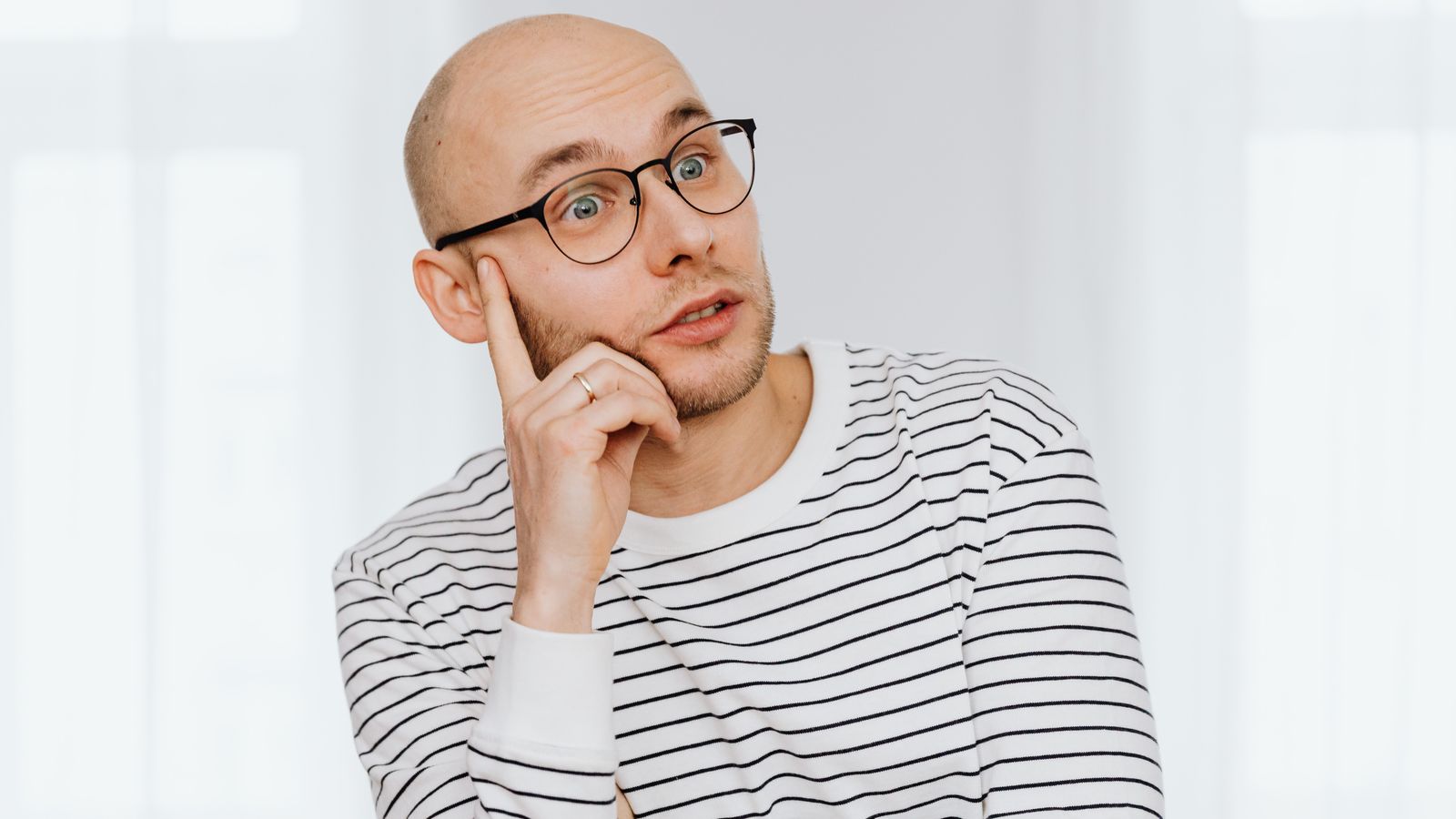 Man reflecting on hair thinning, when to see a trichologist in Bolton