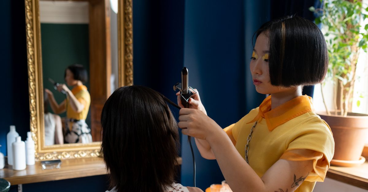 Trichologist Ilford enquiry: a hair and scalp specialist looking closely at a clients strands
