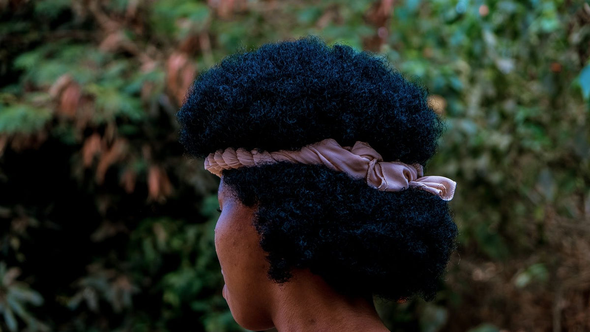 A woman with natural afro hair, the textured hair a trichologist Southwark appointment most often covers
