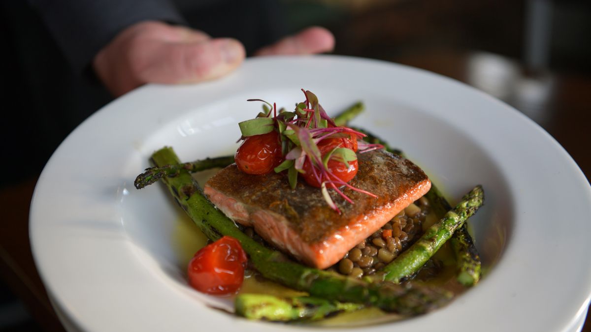 Grilled salmon on lentils with asparagus and tomatoes, a protein-rich plate for anyone searching trichologist Wolverhampton after diet-related hair shedding