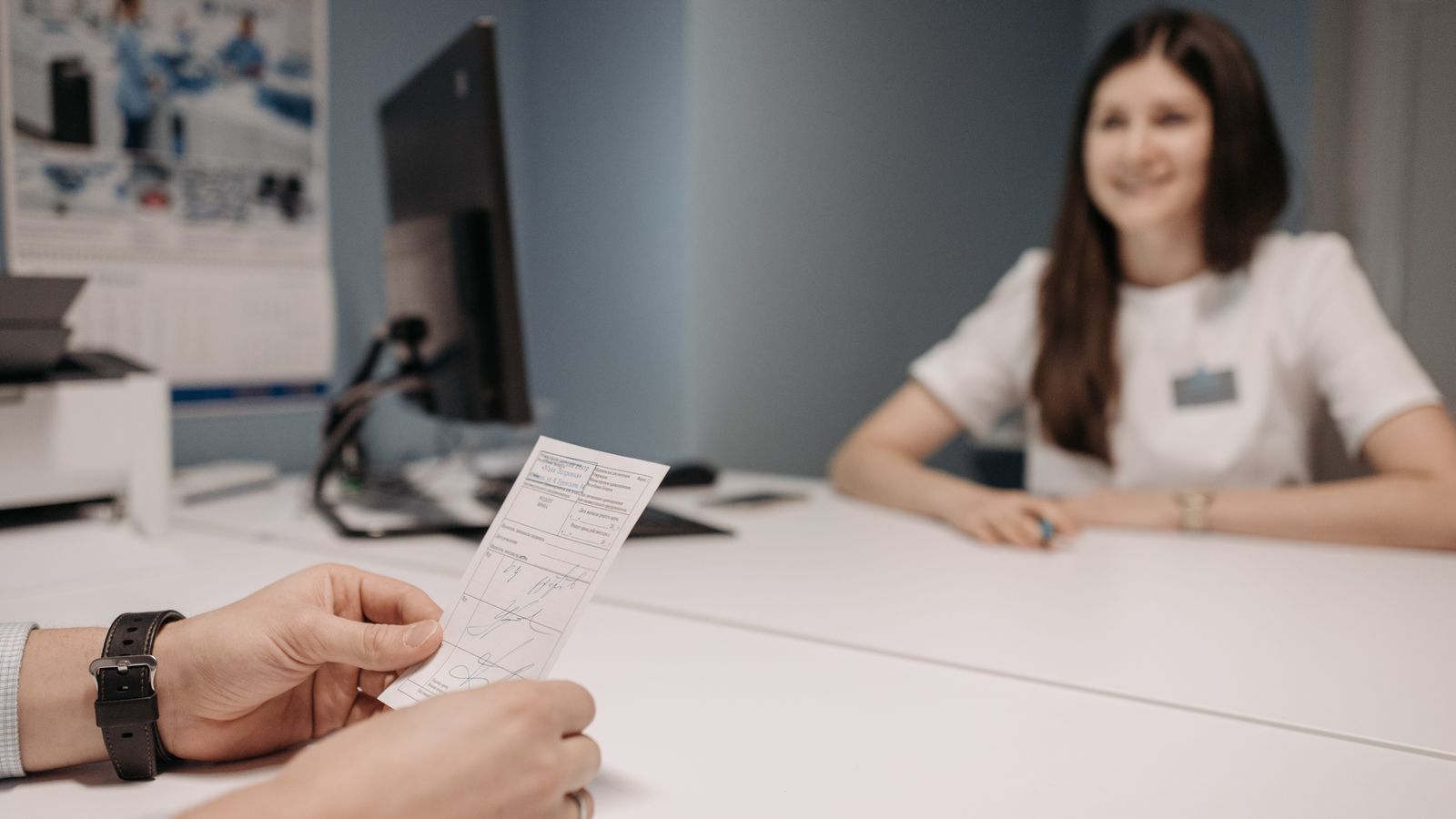 Doctor discussing a patient prescription at a clinic desk, medication and hair shedding, trichologist Worksop