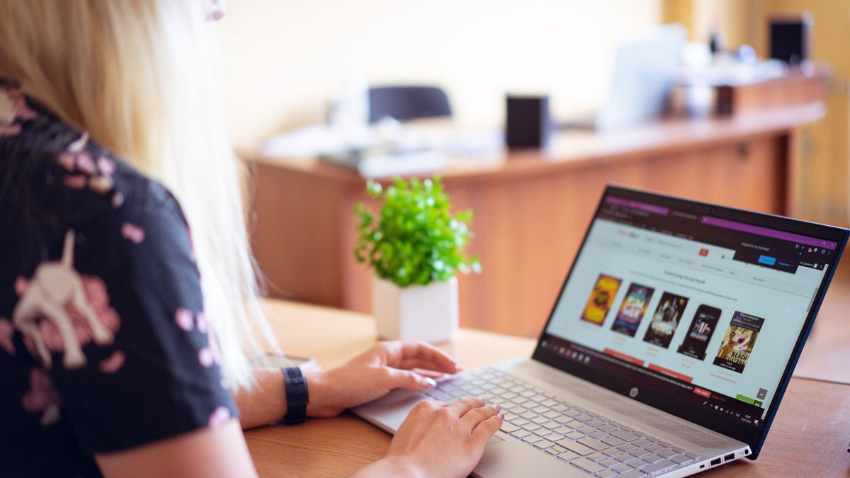 Woman shopping online for hair care on a laptop, checking the seller before buying or searching trichologists Ashford