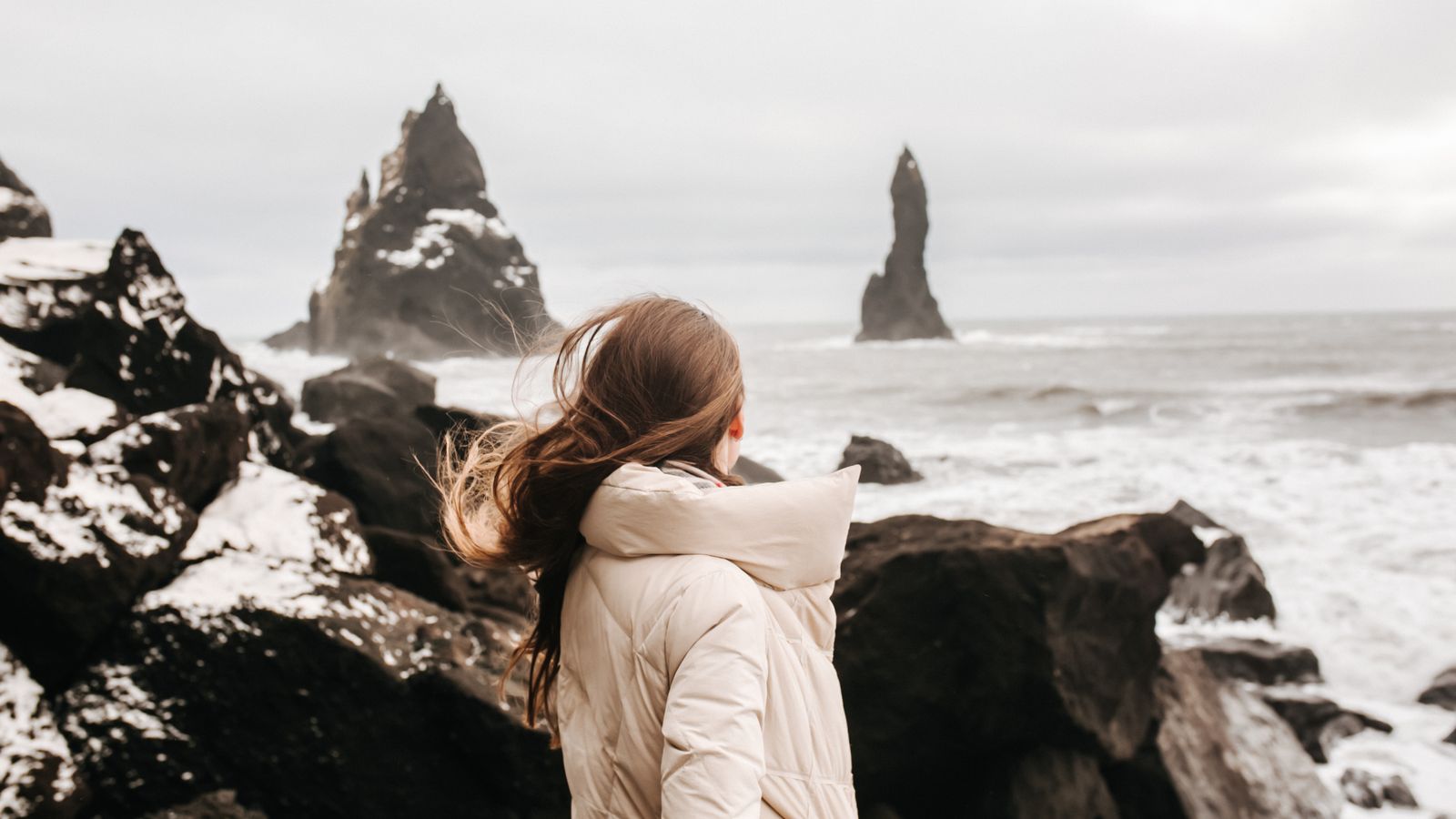 Person on a windswept Highland coastline, the climate trichologists in Inverness account for