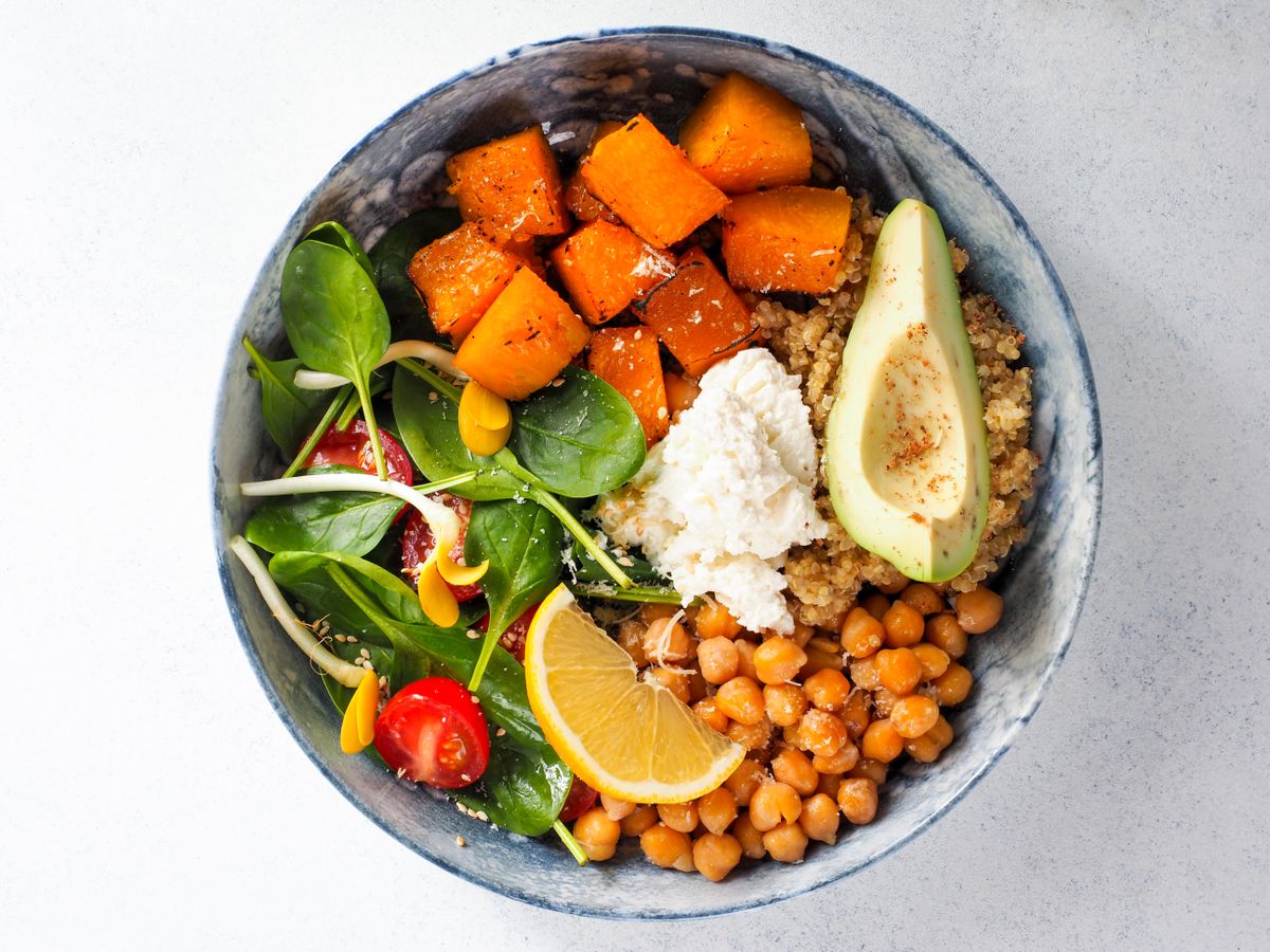 Vegan buddha bowl with chickpeas, avocado, sweet potato and spinach, a plant-based meal to plan well before contacting trichologists Ipswich