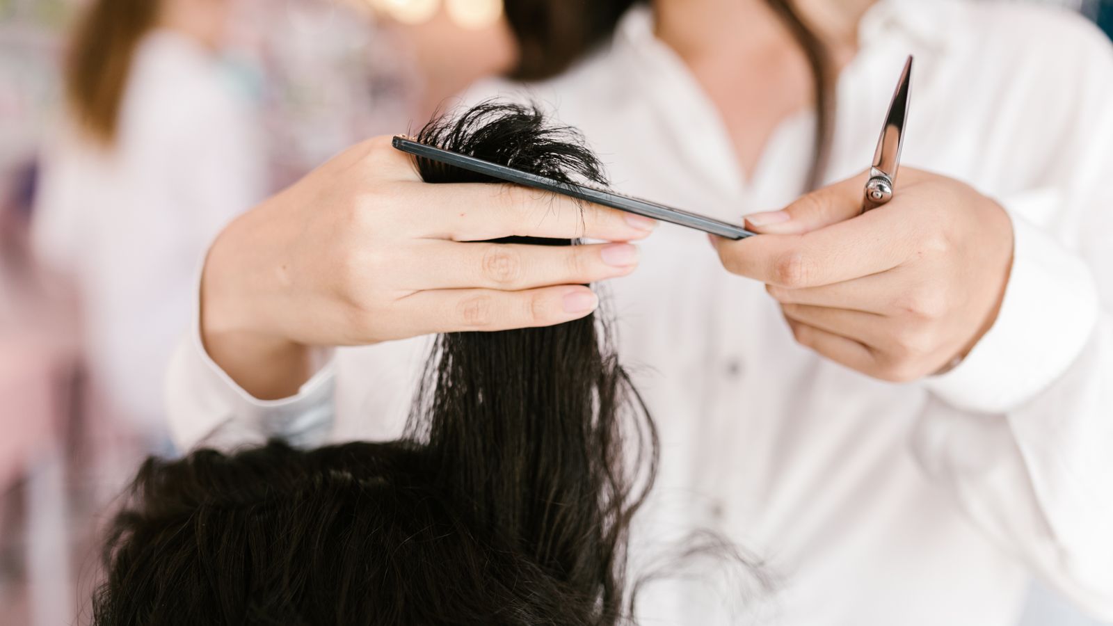 Hairdresser working with a client in a salon, a guide to trichologists in Kilmarnock