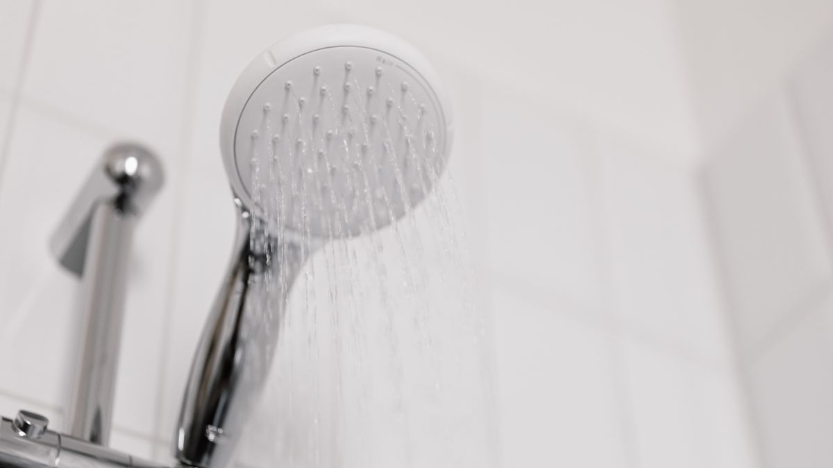 Shower head running hard tap water, the everyday hair concern behind many searches for trichologists Southampton