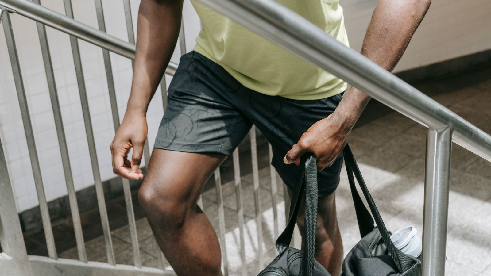 A man carrying a bag up a stairway, the kind of exertion that shows what triggers angina