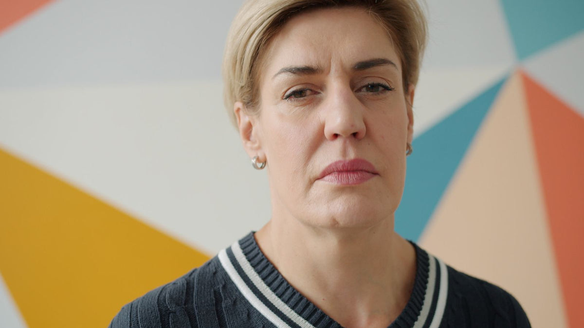 Contemplative middle aged woman indoors, asking why does menopause cause hair loss