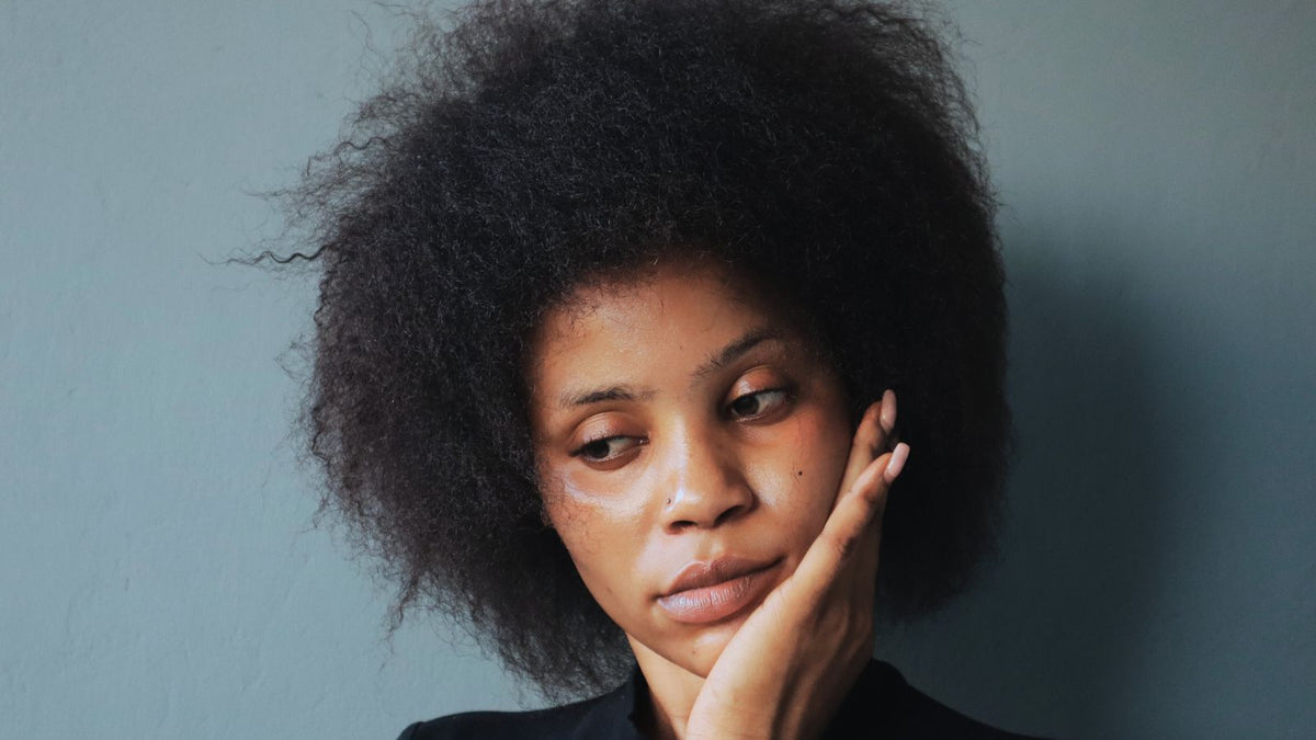 Woman with healthy natural afro hair, the texture that afro hair products are designed to moisturise and protect