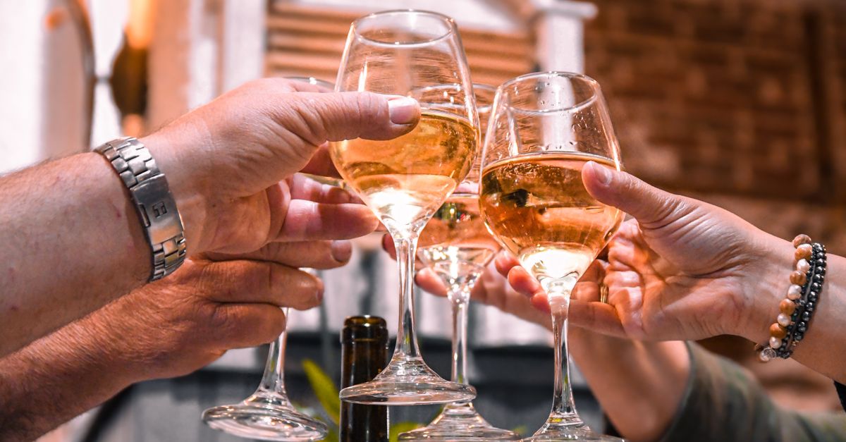 Friends toasting with wine glasses, the everyday side of alcohol and hair health